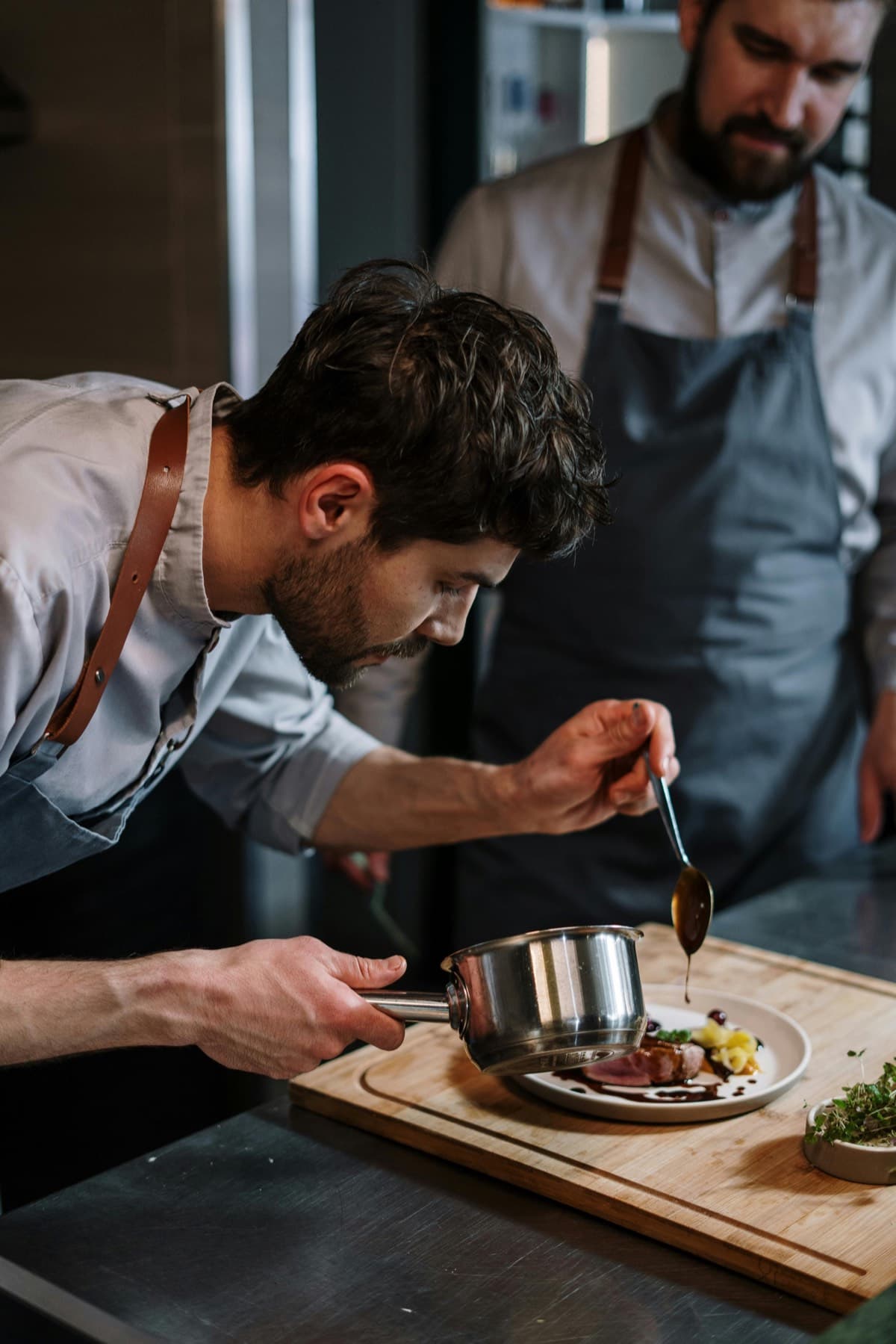 Household chef plating a fine dining dish