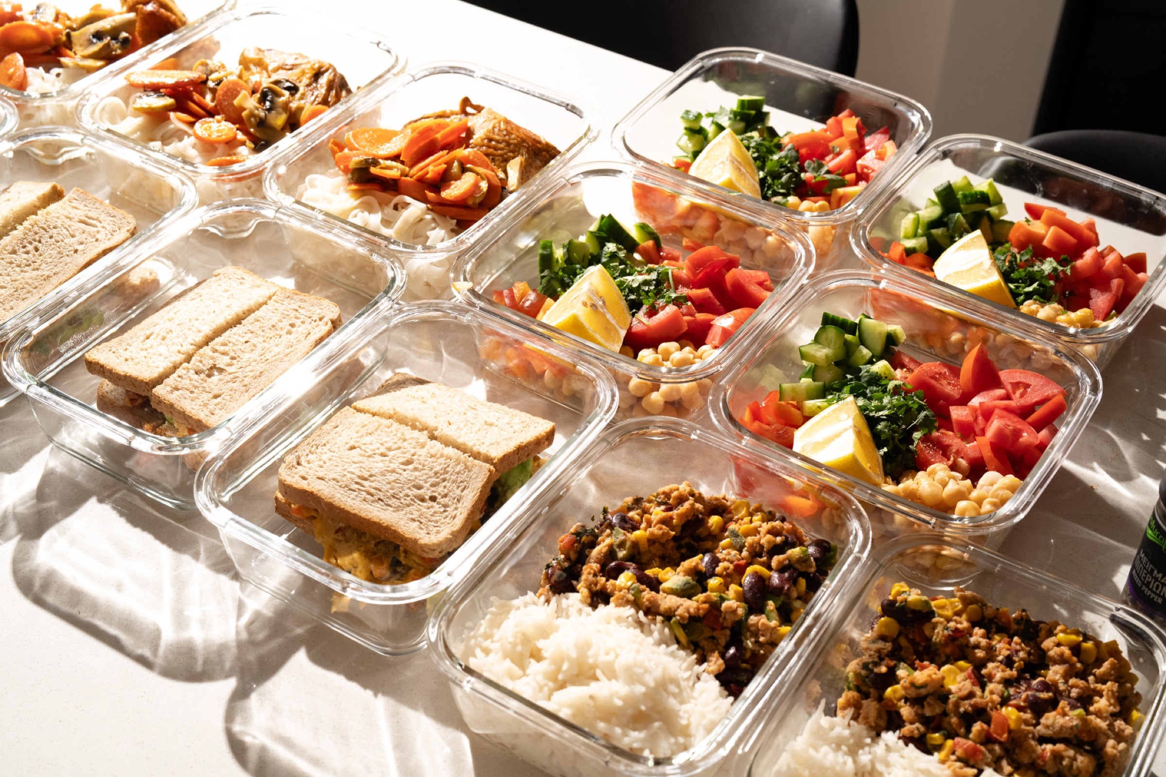 Professional meal prep containers spread on a table